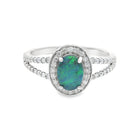 White gold ring with a green opal stone and diamond accents on a white background